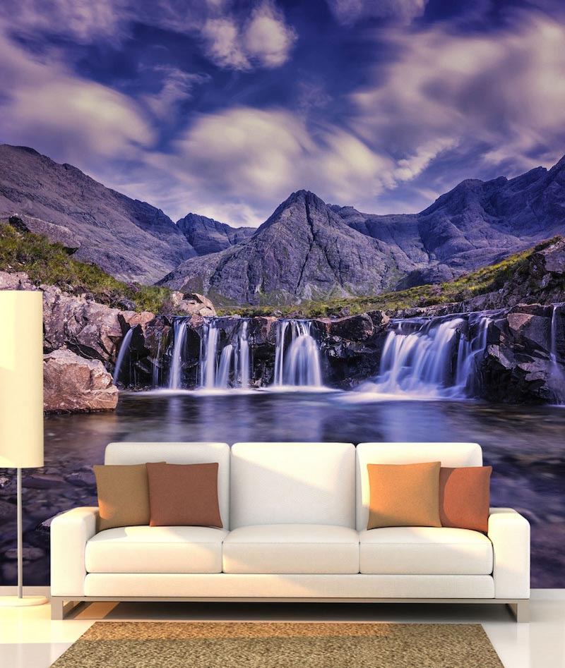 Tall waterfall descending through a rugged mountain landscape