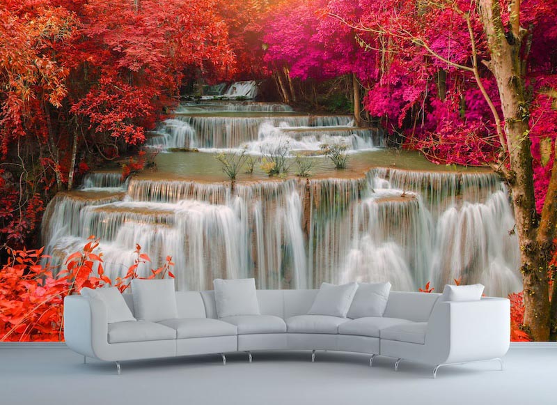 Layered Kanchanaburi waterfalls surrounded by green tropical vegetation