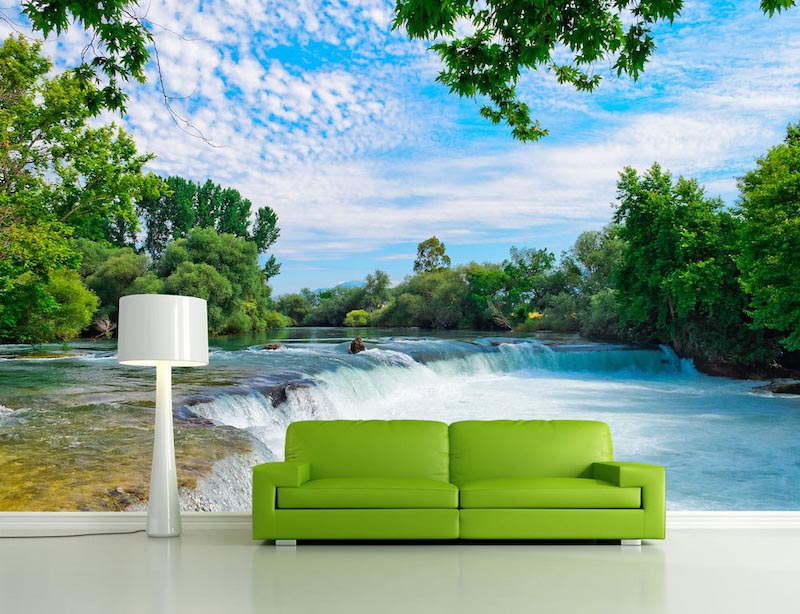 Wide view of Manavgat Waterfall with water flowing across the landscape